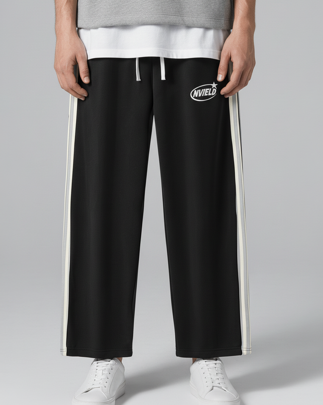 Close-up of the model's lower body wearing NWRLD 002 Side-Stripe Straight-Legs