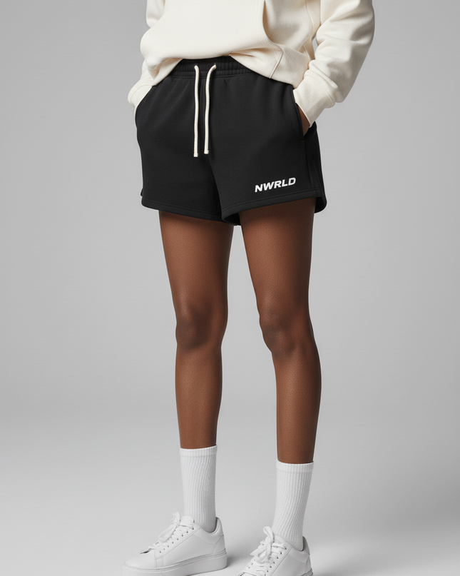 Close-up of the model's lower body wearing NWRLD 002 Fleece Drawstring Shorts