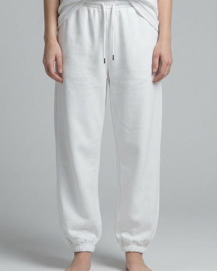 Close-up of the model's lower body wearing Essential Jogged Sweatpants