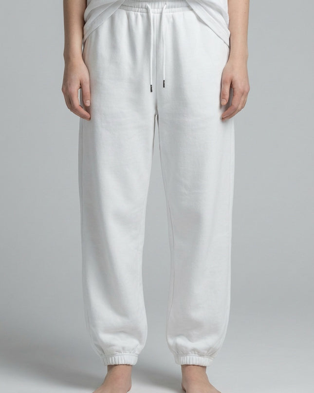 Close-up of the model's lower body wearing Essential Jogged Sweatpants