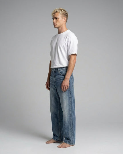 Side profile of the model wearing Sun Fade Heavyweight Denim Jeans