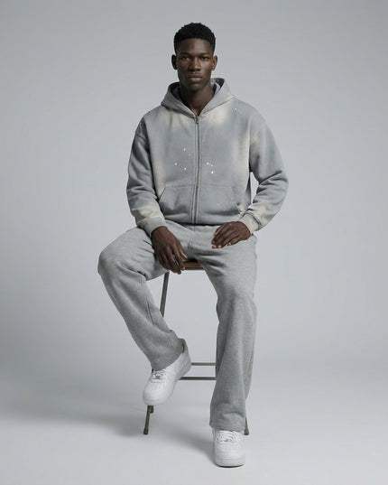 Model sitting while wearing Sun Fade Frayed Raw Edge Fleece Zip Hoodie