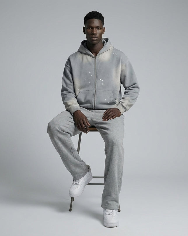 Model sitting while wearing Sun Fade Frayed Raw Edge Fleece Zip Hoodie