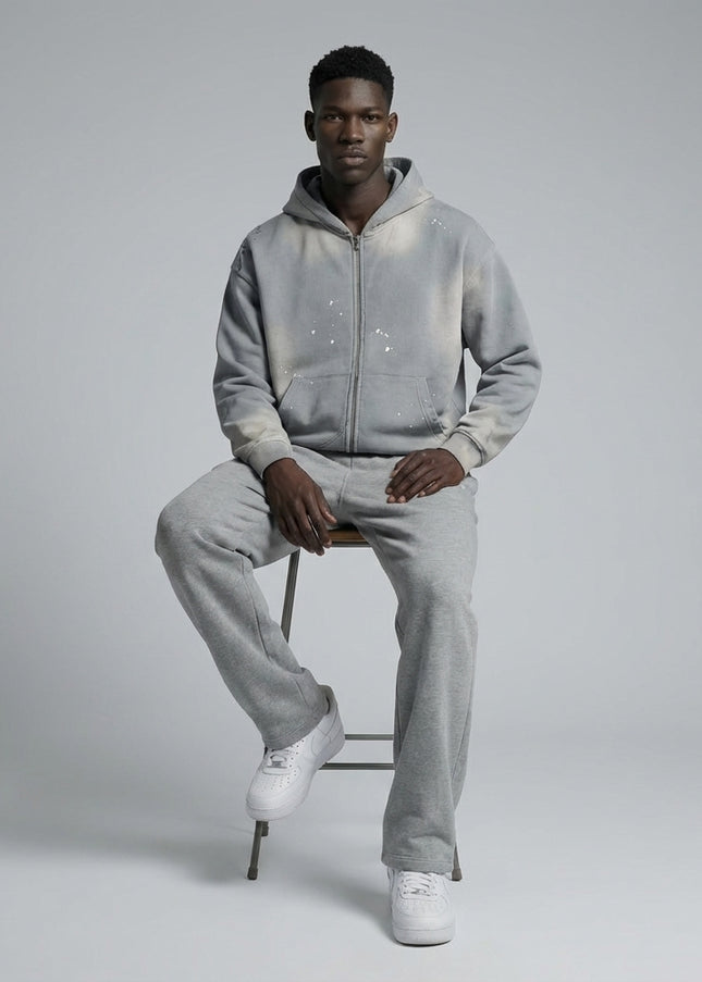 Model sitting while wearing Sun Fade Frayed Raw Edge Fleece Zip Hoodie