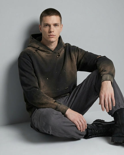 Model sitting while wearing Sun Fade Frayed Fleece Hoodie