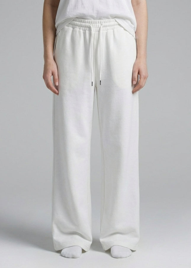 Close-up of the model's lower body wearing Essential Straight-Leg Sweatpants