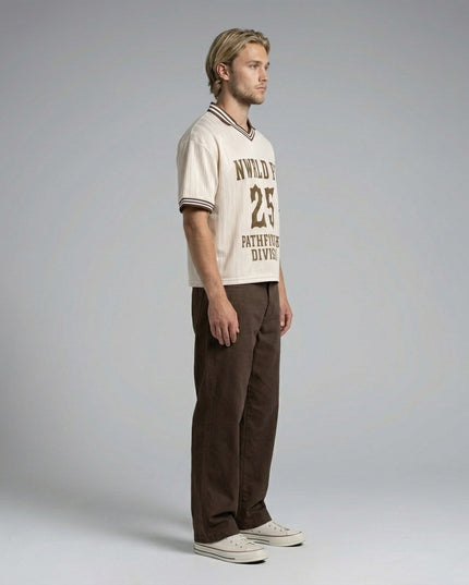 Side profile of the model wearing NWRLD 002 Pathfinders Football T-Shirt