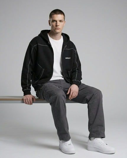Model sitting while wearing Contrast-Stitched Boxy Fleece Zip Hoodie