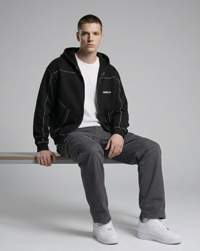 Model sitting while wearing Contrast-Stitched Boxy Fleece Zip Hoodie