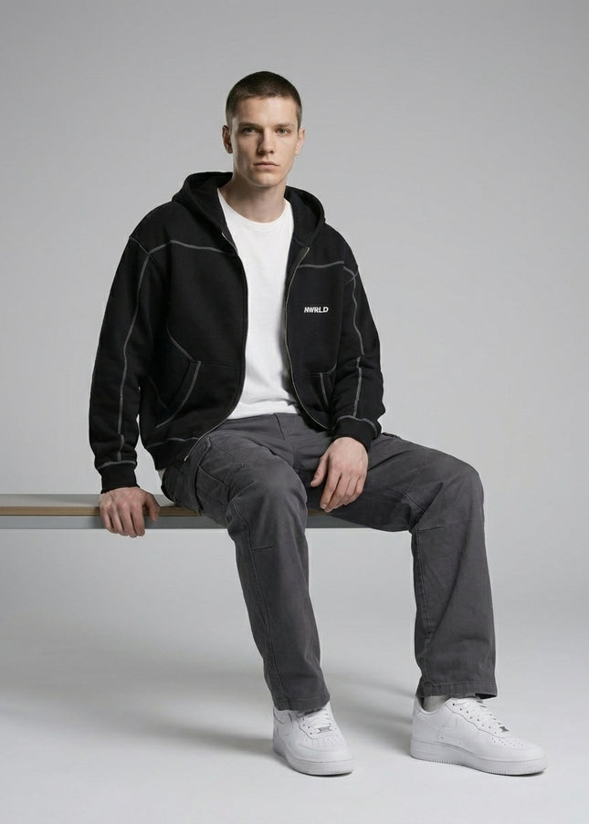 Model sitting while wearing Contrast-Stitched Boxy Fleece Zip Hoodie