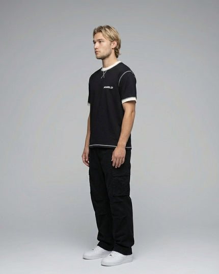 Side profile of the model wearing Contrast-Stitched Cotton T-Shirt