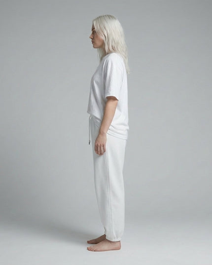 Side profile of the model wearing Essential Jogged Sweatpants