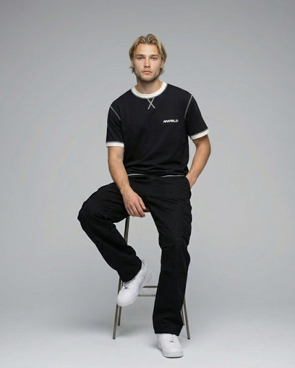 Model sitting while wearing Contrast-Stitched Cotton T-Shirt