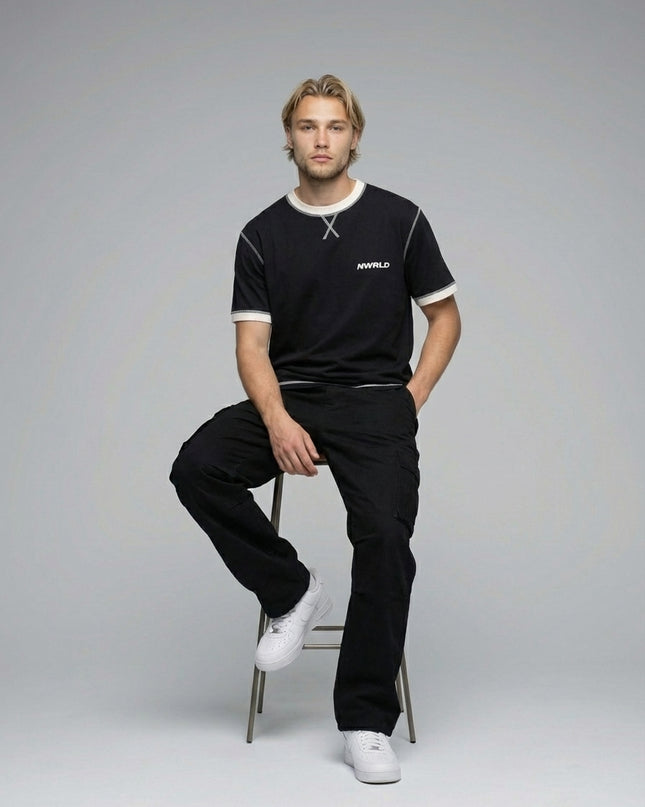 Model sitting while wearing Contrast-Stitched Cotton T-Shirt