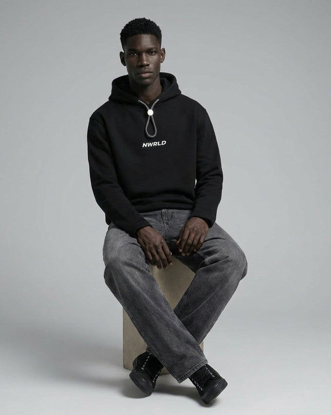 Model sitting while wearing Oversized Fleece Hoodie