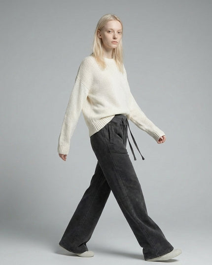 Model walking while wearing DROP 003 / Vintage Washed Flared Fleece Pants