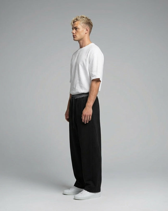 Side profile of the model wearing Plaid Waistband Barrel Sweatpants