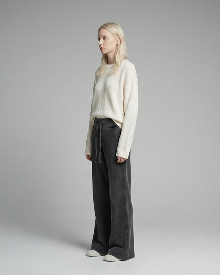 Side profile of the model wearing DROP 003 / Vintage Washed Flared Fleece Pants
