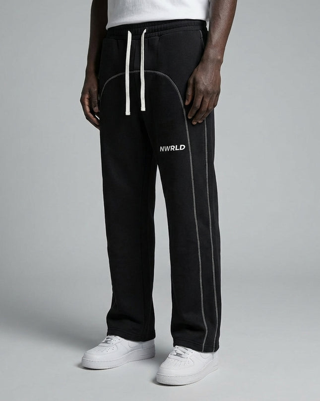 Close-up of the model's lower body wearing Contrast-Stitched Fleece Sweatpants