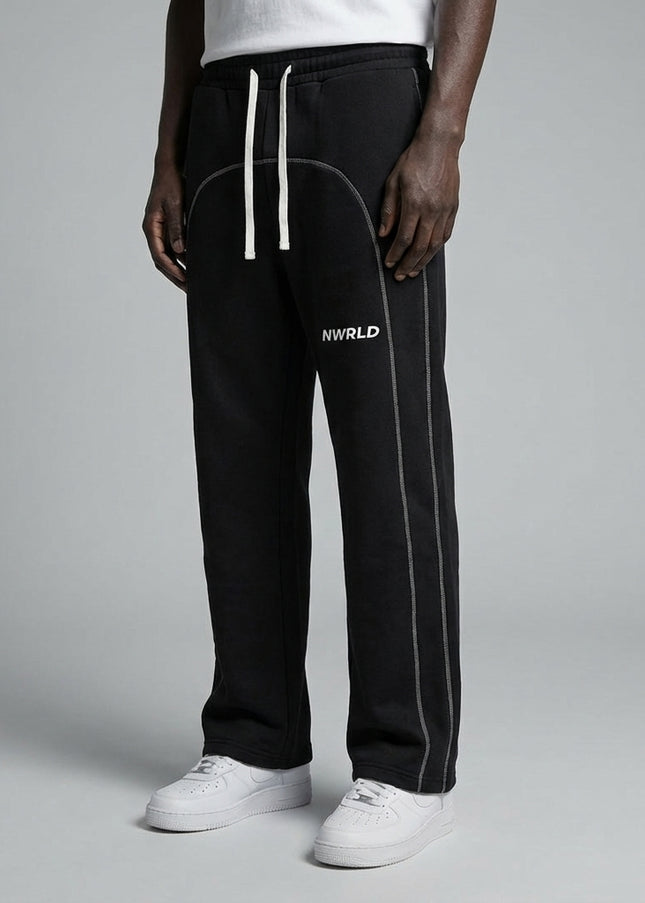Close-up of the model's lower body wearing Contrast-Stitched Fleece Sweatpants