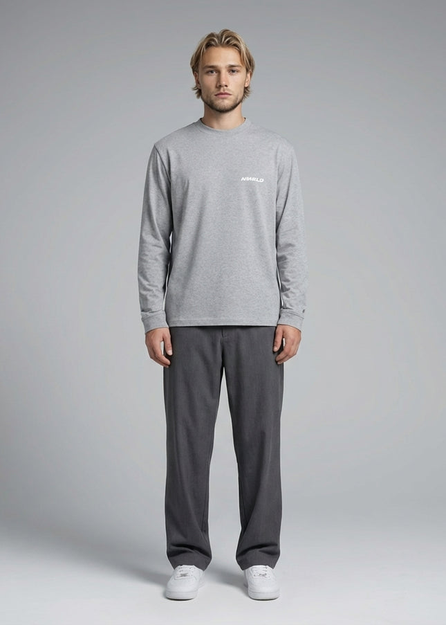 Full body view of the model wearing Essential Crewneck Long-Sleeve T-Shirt