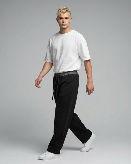 Model walking while wearing Plaid Waistband Barrel Sweatpants