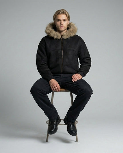 Model sitting while wearing Sun Fade Boxy Detachable Fur Hoodie