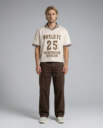 Full body view of the model wearing NWRLD 002 Pathfinders Football T-Shirt