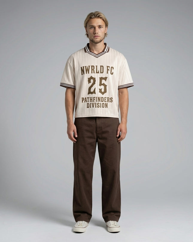 Full body view of the model wearing NWRLD 002 Pathfinders Football T-Shirt